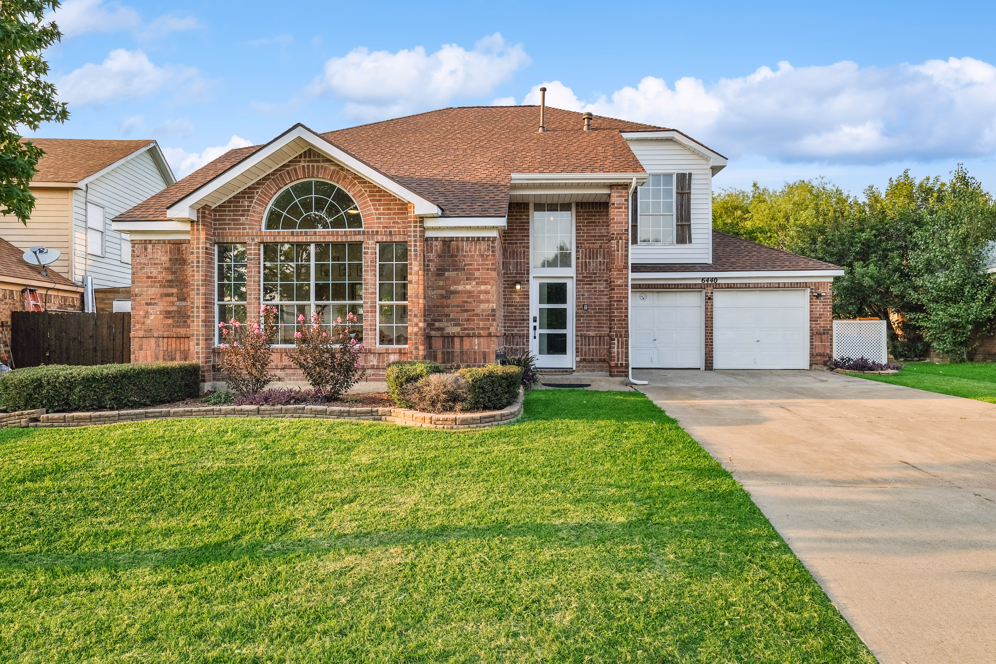 Front yard angle — house facade and lawn from the side.