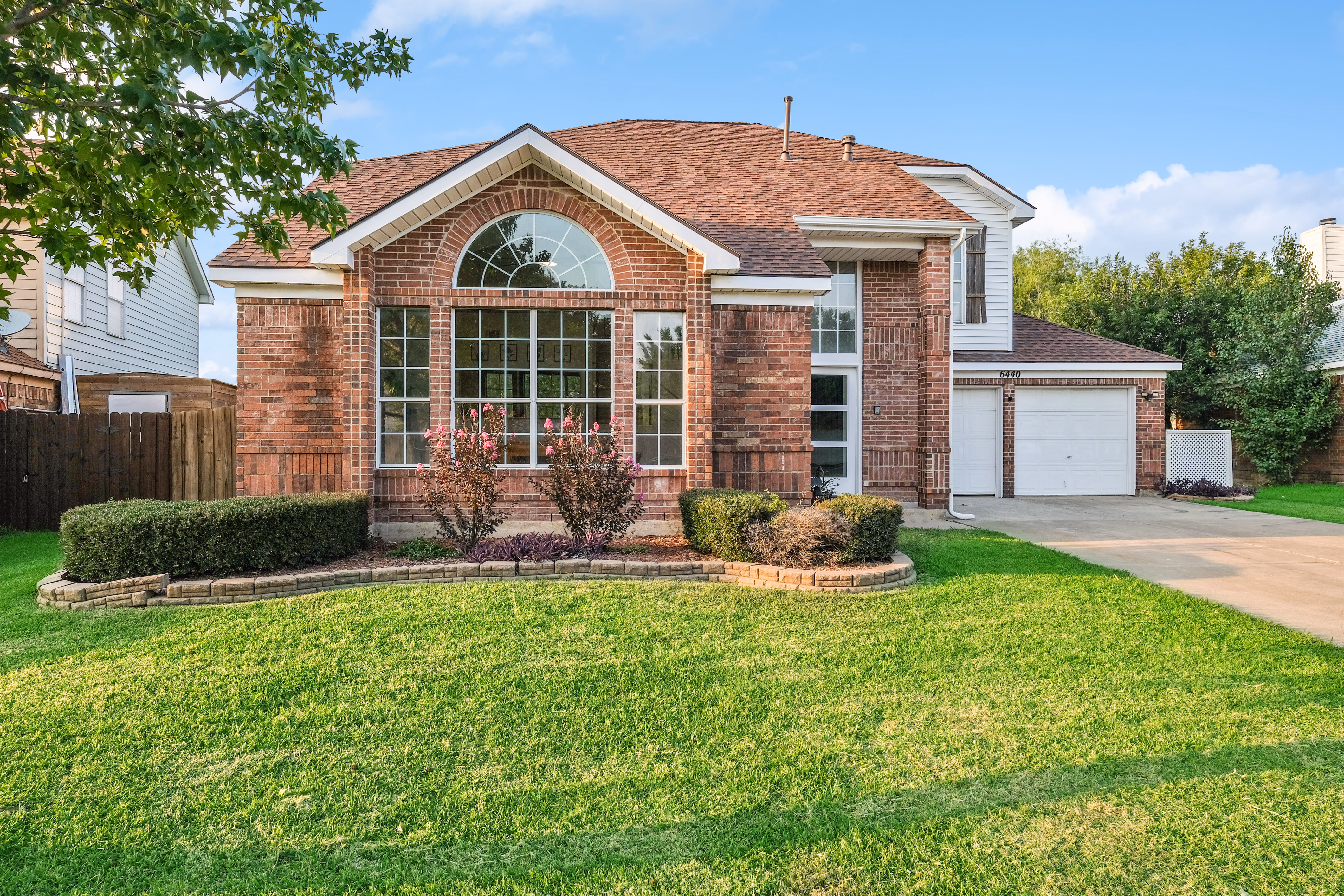 Front facade from opposite side — arched window prominent.