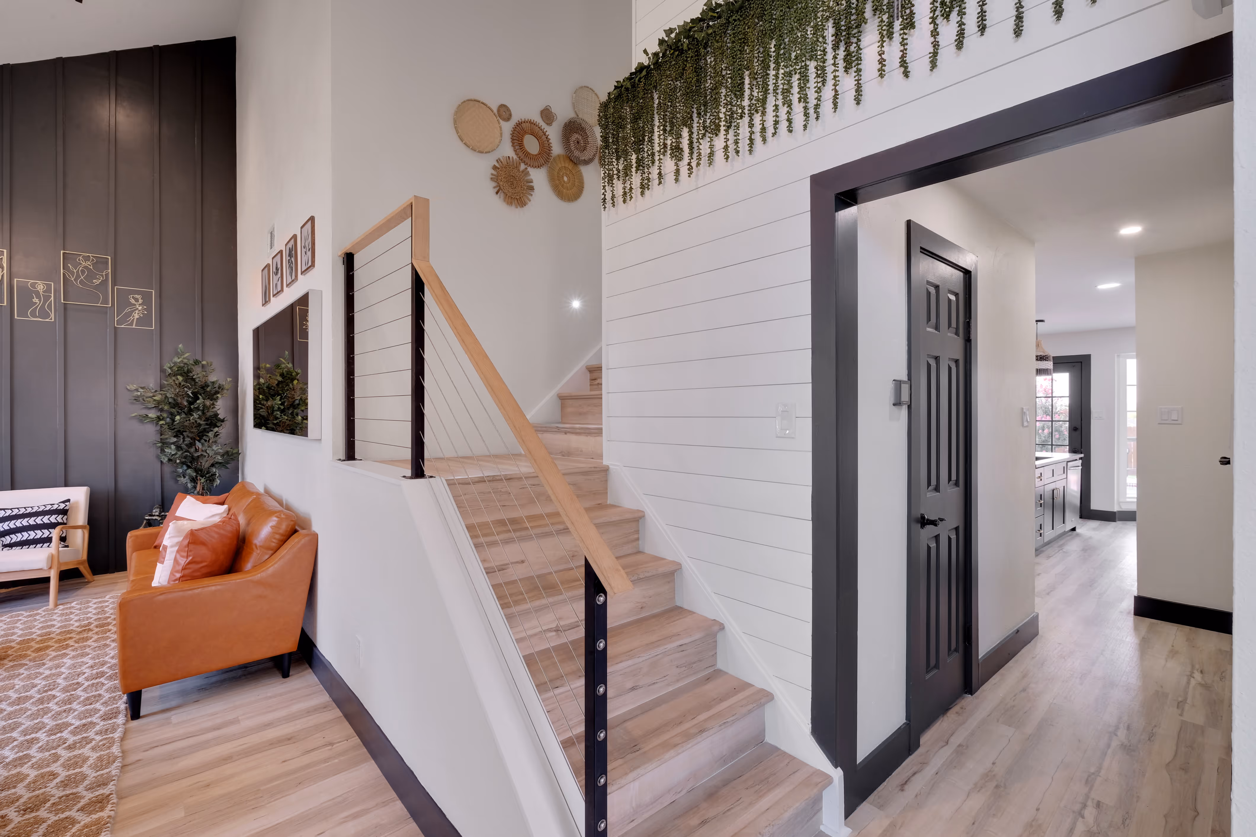 Knoll Ridge — Foyer — staircase with cable rail, shiplap, view to kitchen.