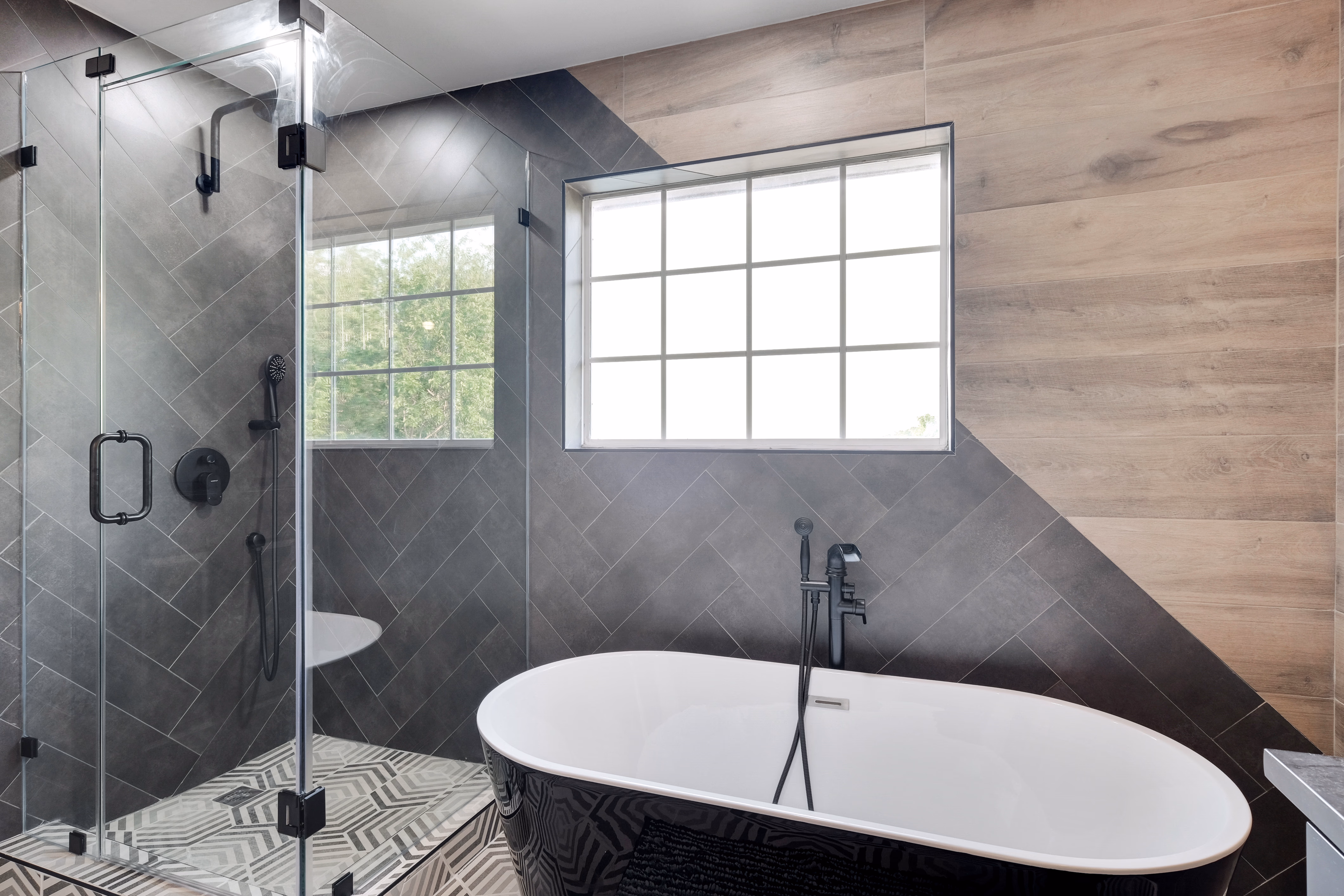 Master bath — walk-in shower with herringbone tile and soaking tub.